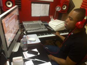 A man wearing headphones in front of a computer.