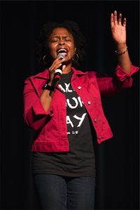 A woman singing into a microphone.