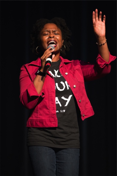 A woman singing into a microphone.