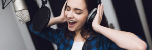 A woman singing a song in a modern recording studio