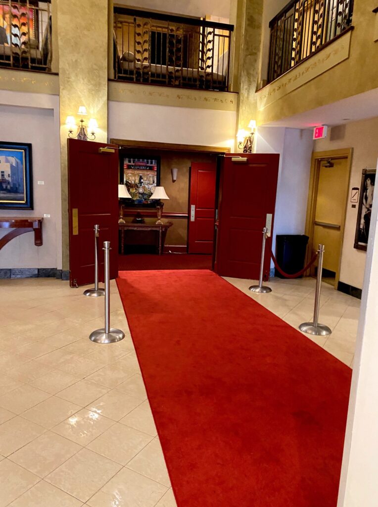 A red carpet in the lobby of a building.
